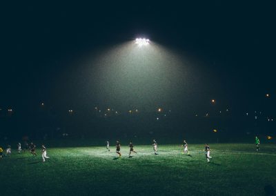 group of people playing soccer on soccer field