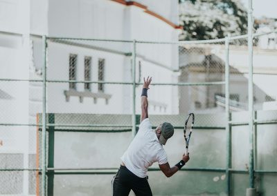 man in white t-shirt playing basketball during daytime