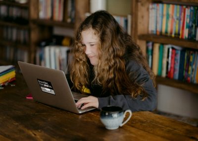 woman in black jacket using macbook pro